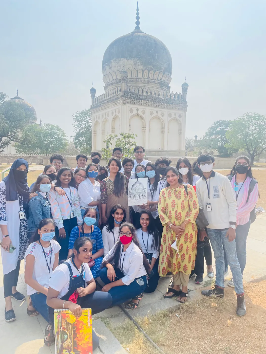 Workshop group in front of a domed tomb